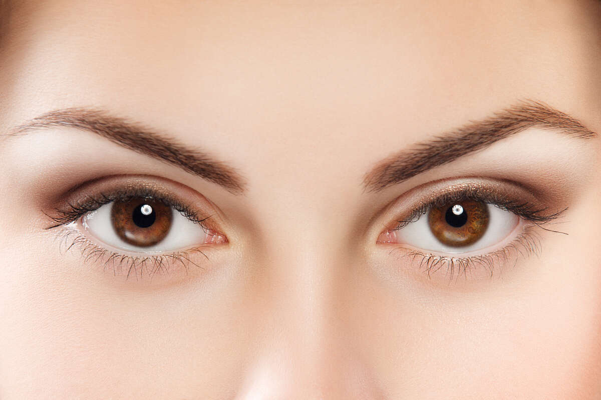 A close picture of woman's brown eyes.