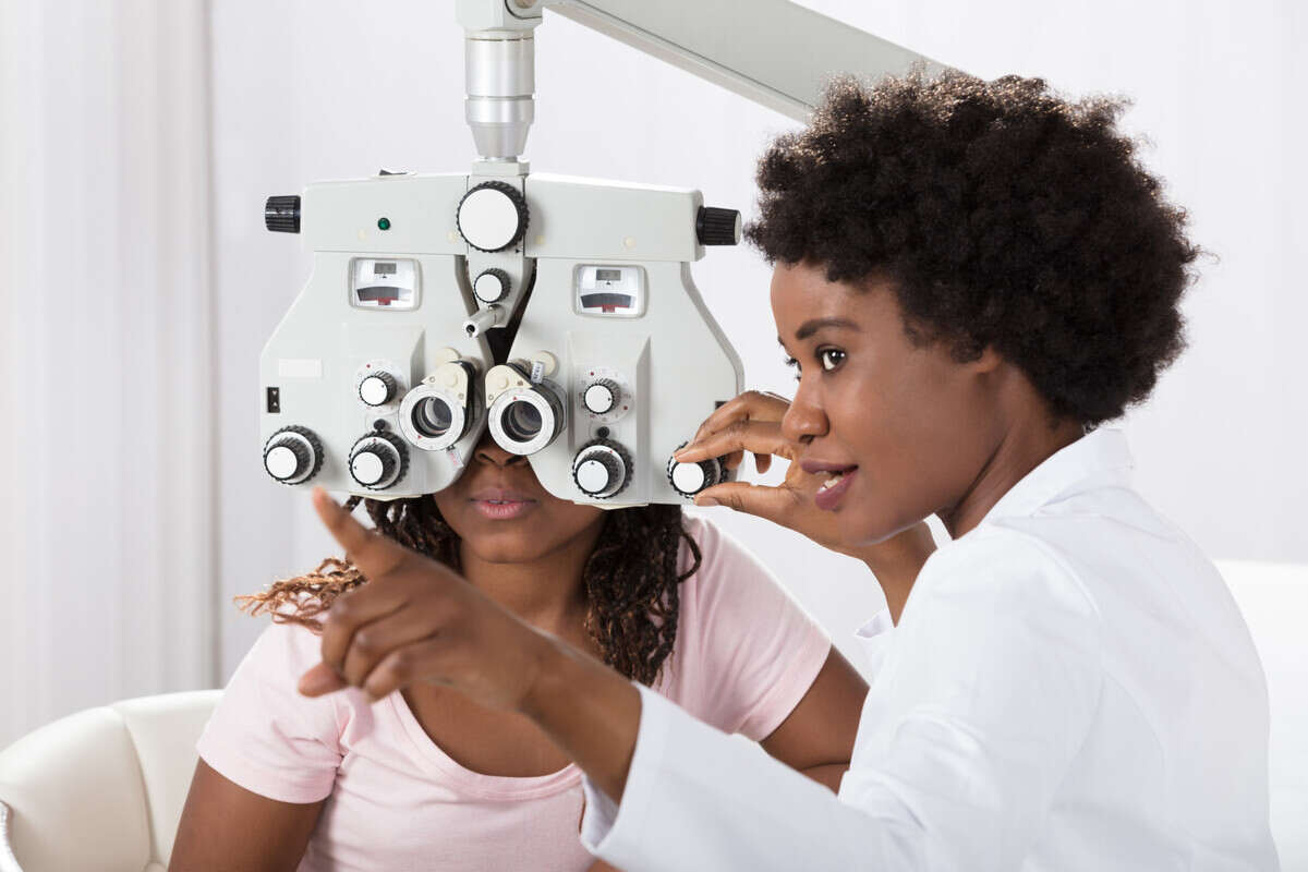 An optometrist examining the eyes of a patient.